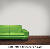 Green sofa, white wall, dark floor Green sofa, white wall, dark floor