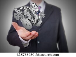 Businessman showing gears Businessman showing gears