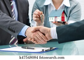 Handshakes with customer after contract signature