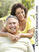 Senior Couple Relaxing In Garden Together Senior Couple Relaxing In Garden Together