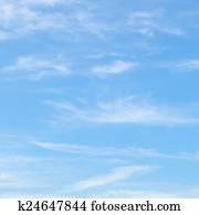 fluffy clouds in the blue sky