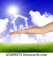 House in the hands against the blue sky House in the hands against the blue sky