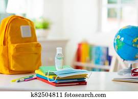 Backpack of school child. Face mask and sanitizer. Backpack of school child. Face mask and sanitizer.