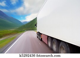 Motion of white semi-truck on the mountain road