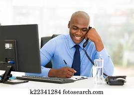 african businessman talking on landline phone