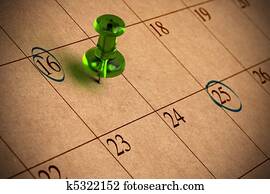 Calendar with numbers, green thumbtack, recycled paper 