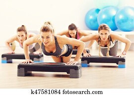Group of smiling people doing push-ups Group of smiling people doing push-ups