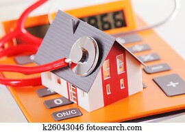 Miniature Home with Stethoscope on a Calculator