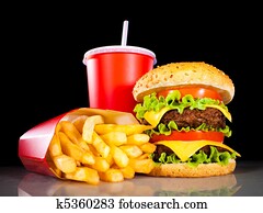 Tasty hamburger and french fries on a dark Tasty hamburger and french fries on a dark