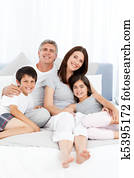 Family  lying down on their bed