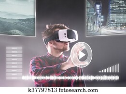 Man wearing virtual reality goggles. Studio shot, black backgrou