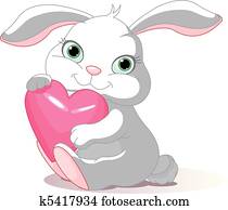 Rabbit holds love heart