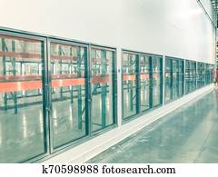 Vintage tone row of empty commercial fridges at wholesale big-box store Vintage tone row of empty commercial fridges at wholesale big-box store