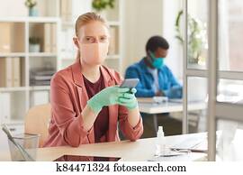 Young Woman Wearing PPE in Office Young Woman Wearing PPE in Office