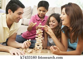 Family Playing Game Together At Home Family Playing Game Together At Home