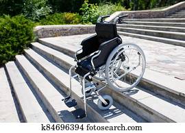 Wheelchair near the steps in a spring park. Wheelchair near the steps in a spring park.