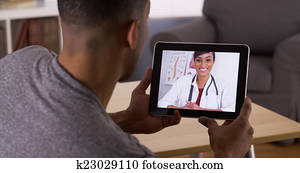 Black man listening to doctor on tablet Black man listening to doctor on tablet