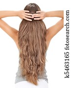 Brunette lady holding long hairs, view from back side isolated on white