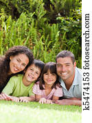 Happy family lying down in the garden