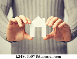 man holding paper house man holding paper house