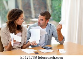 Young couple calculating their domestic bills