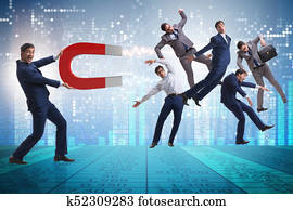 Businessman in recruitment concept with horseshoe magnet