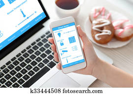 female hand holding phone with smart home on the screen 