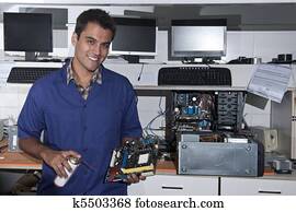 computer technician with motherboard at workshop computer technician with motherboard at workshop