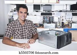 Happy owner of a computer repair store Happy owner of a computer repair store