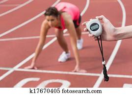 Hand timing a woman's run on the running track
