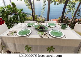 Tasteful and sophisticated prepared table awaits the arrival of guests Tasteful and sophisticated prepared table awaits the arrival of guests