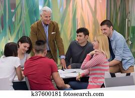 teacher with a group of students in classroom teacher with a group of students in classroom