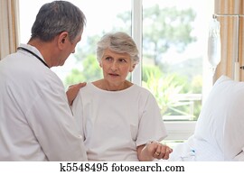 Mature doctor with his patient