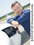 Portrait of man stood next to plane