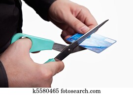 Cutting debts concept - scissors and credit card Cutting debts concept - scissors and credit card
