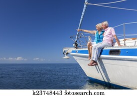 Happy Senior Couple Sailing on a Sail Boat Happy Senior Couple Sailing on a Sail Boat