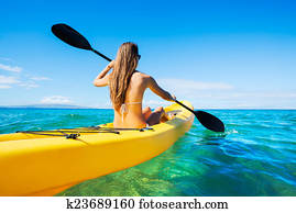 Woman Kayaking in the Ocean on Vacation Woman Kayaking in the Ocean on Vacation