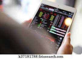 Making trading online on the tablet with business woman hand