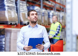 businessman with clipboard at warehouse businessman with clipboard at warehouse