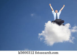 young businessman with computer sitting on the cloud