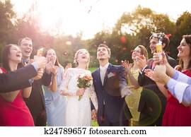 Newlyweds with guest on their garden party