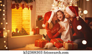 Merry Christmas! happy family mother father and child with gifts near tree
