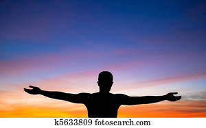 a silhouette of a man on background of beautiful sunset 