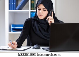 Muslim woman working in office