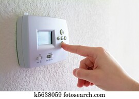Thermostat and human hand 