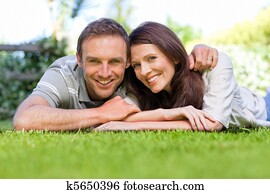 Couple lying down in the garden