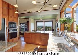 Pendant lighting in modern white kitchen with hob built ...