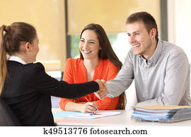 Happy customers handshaking after a deal