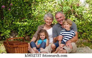 Happy family picnicking in the gard Happy family picnicking in the gard