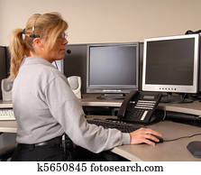 Police dispatcher working at console Police dispatcher working at console